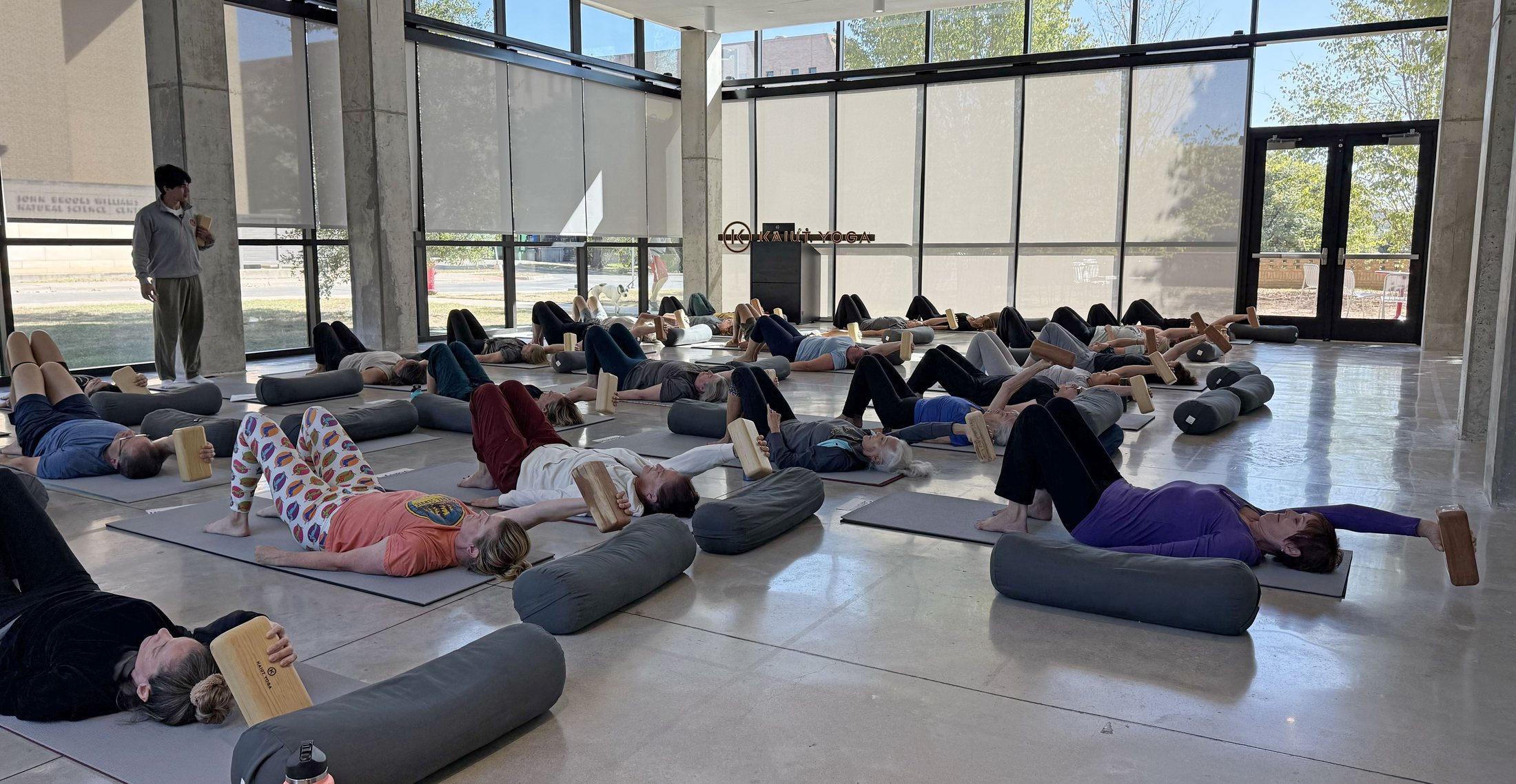 A full Kaiut Yoga class working with wooden blocks in the bright Austin room